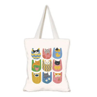 Tote bag with colorful cat illustrations on a white background