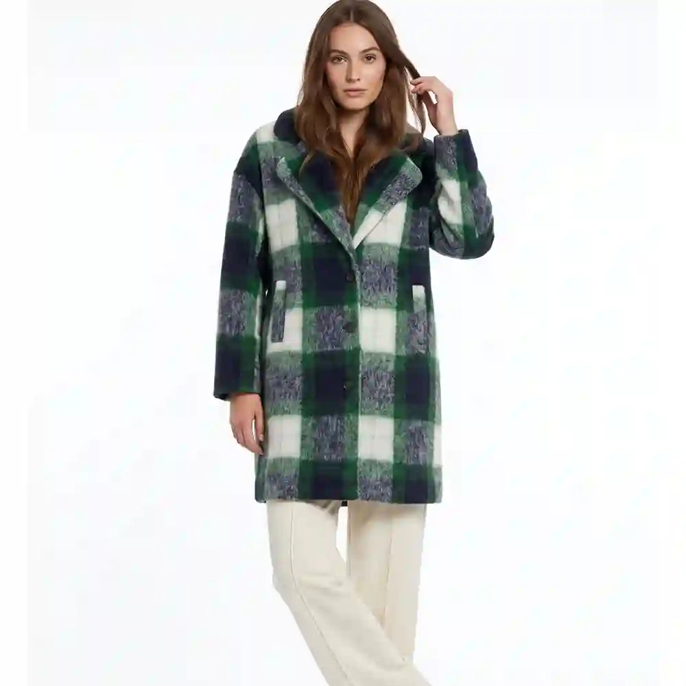 A woman modeling a mid-length green and white plaid coat with a fuzzy texture, paired with cream-colored pants, against a plain white background.