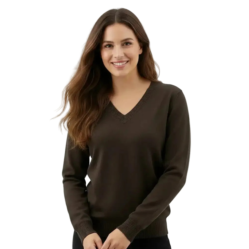 A woman with long brown hair wearing a dark brown V-neck knit sweater, standing against a plain white studio background.