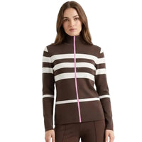A woman modeling a brown mock-neck knit sweater with horizontal cream stripes and a bright pink front zipper, paired with matching brown pants against a plain white background.