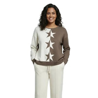 A woman modeling a crewneck sweatshirt with a vertical star pattern in brown and off-white, paired with off-white pants, against a solid light gray studio background.