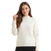 A woman modeling a cream-colored knit sweater with a textured geometric star design on the front, set against a plain white background.