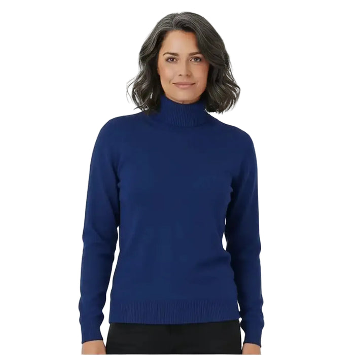 A woman wearing a solid royal blue mock neck knit sweater, paired with black pants, photographed against a clean white studio background.