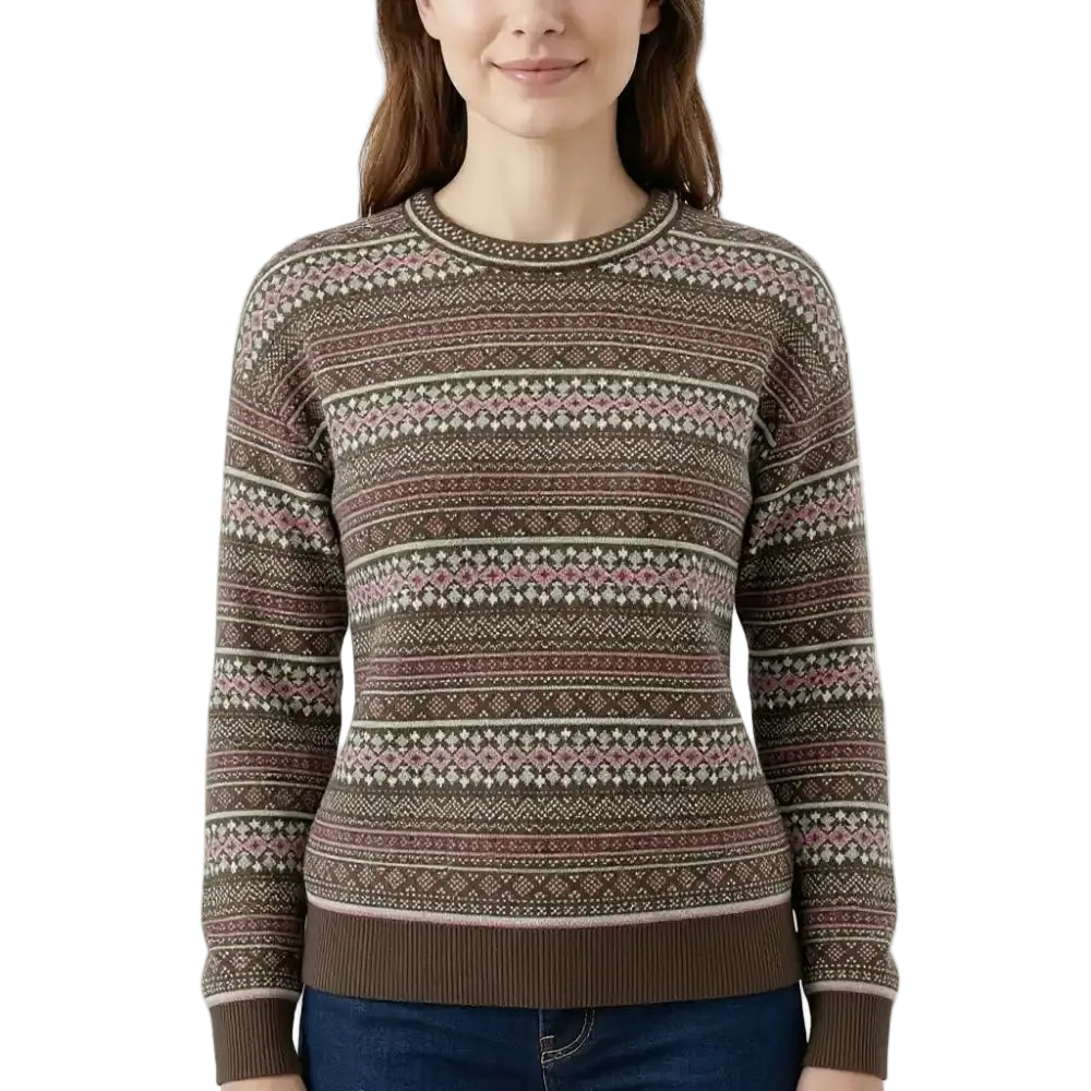 A woman wearing a long-sleeve crewneck sweater with a brown, pink, and cream Fair Isle pattern, paired with blue jeans against a plain white background.