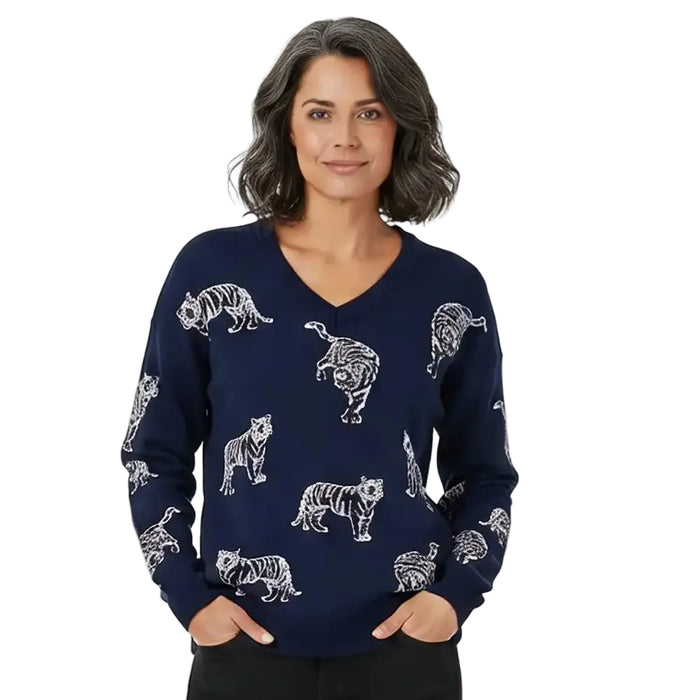A woman wearing a navy blue long-sleeve V-neck sweater with a white tiger print, posed against a solid white background.