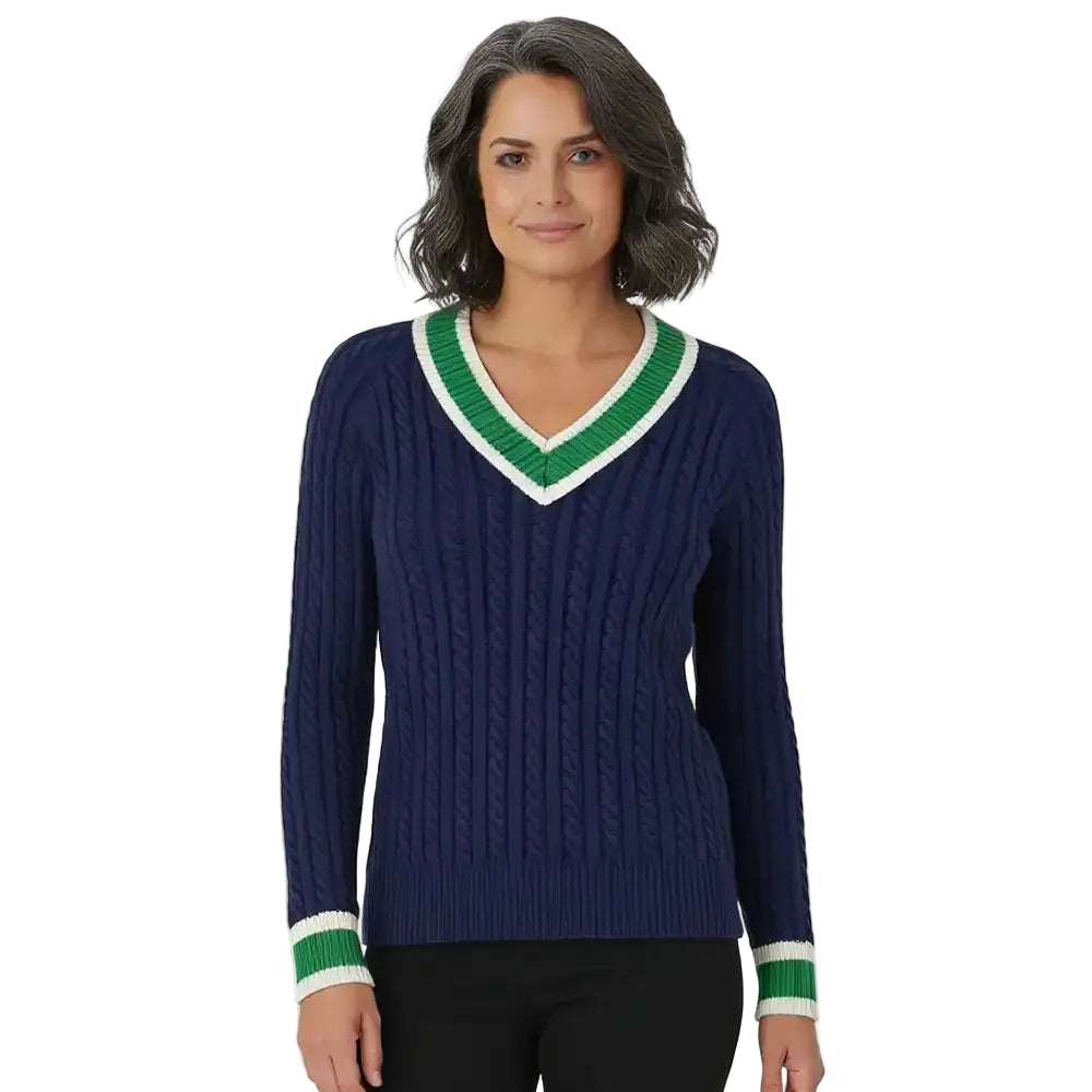 Woman wearing navy blue V necked cable knit jumper with green and white edging.