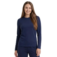 A woman modeling a navy blue long-sleeve crewneck top and matching navy pants against a clean white studio background.
