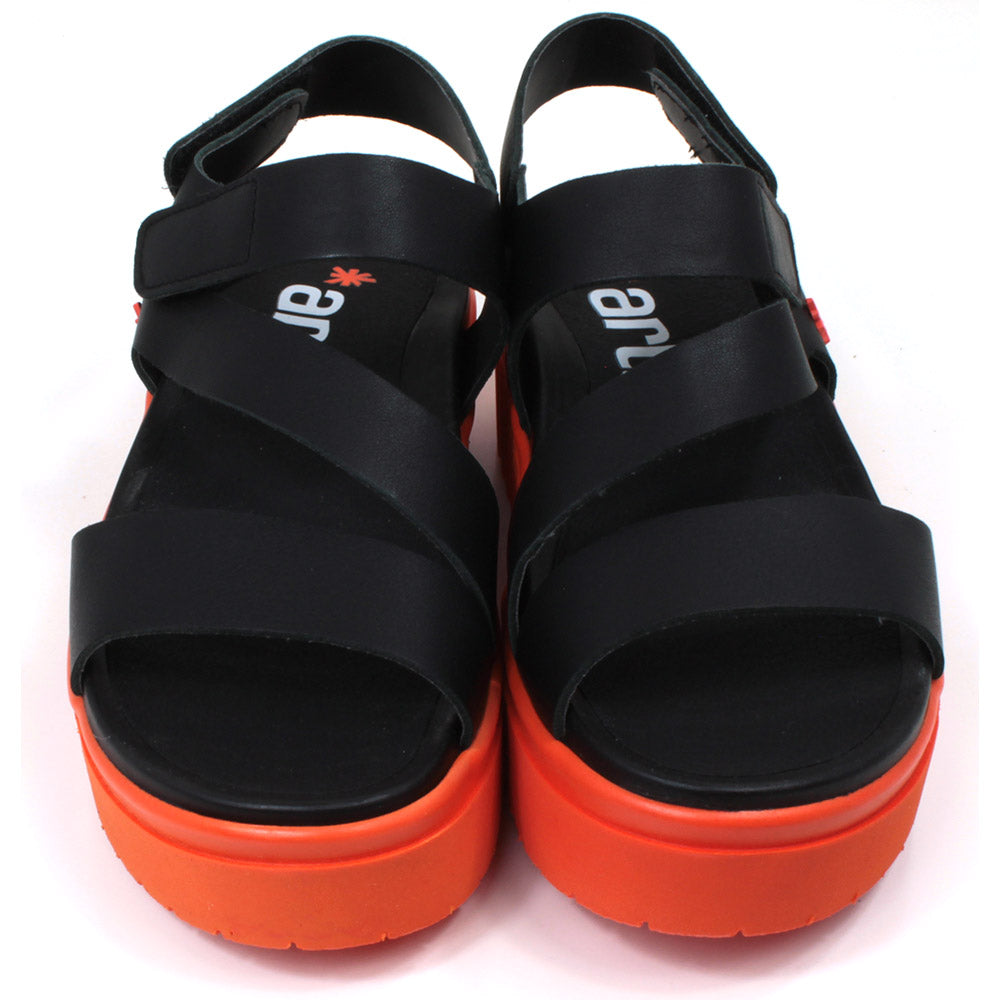 Art black sandals. Black footbed and bright orange ridged orange soles. Front view.