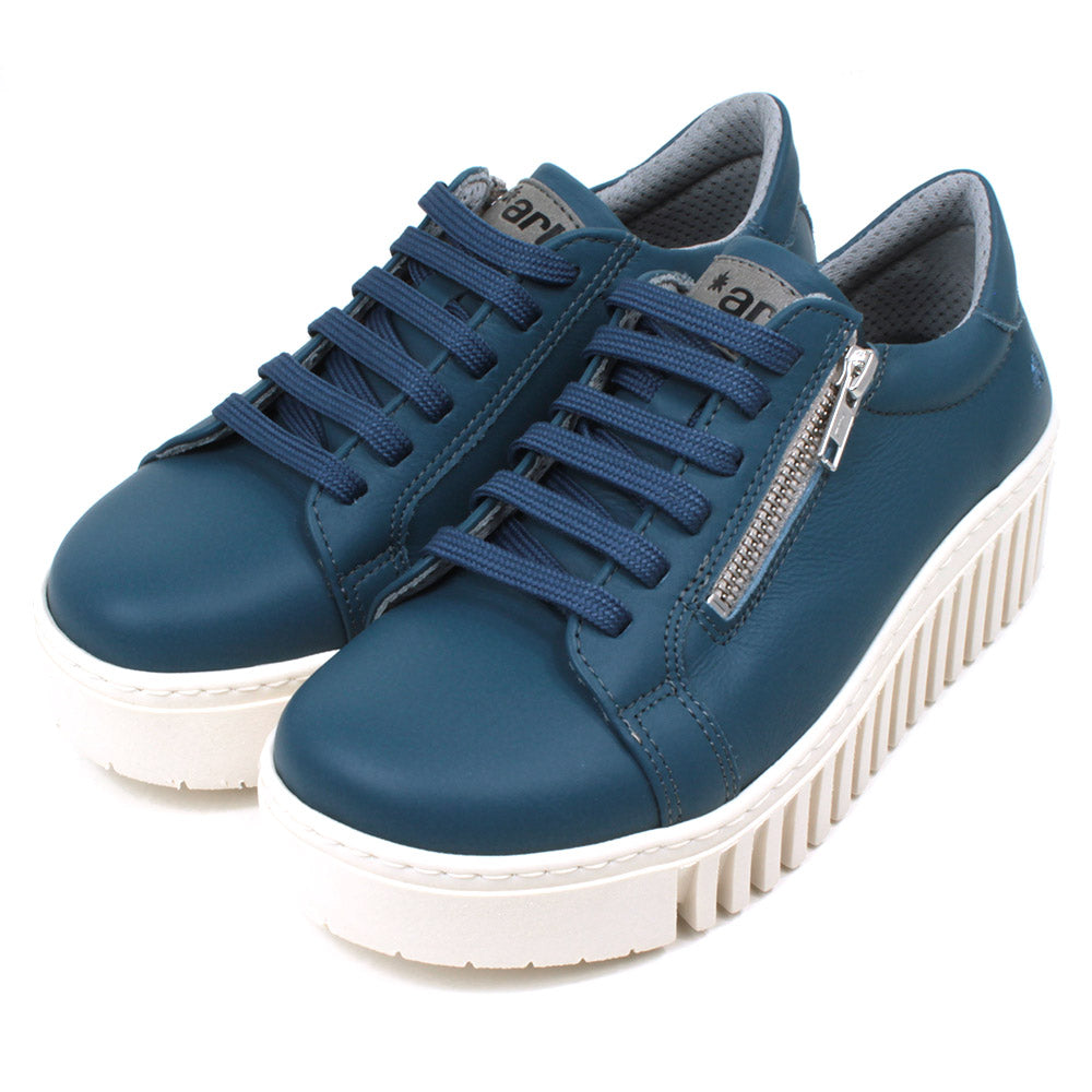 Art Metropolitan blue trainers with white ridged platform soles. Blue laces for adjustment and side zips for fitting. Angled view.