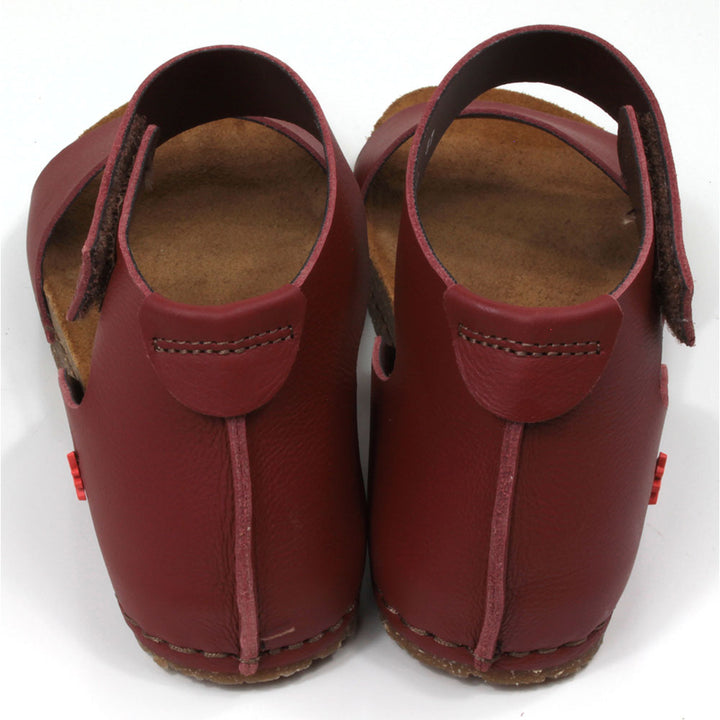 Art red tan sandals with single wide footstrap and Velcro fitting around the ankle. Tan coloured footbeds. Back view