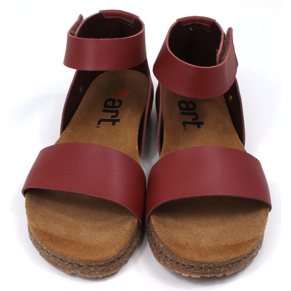 Art red tan sandals with single wide footstrap and Velcro fitting around the ankle. Tan coloured footbeds. Front view