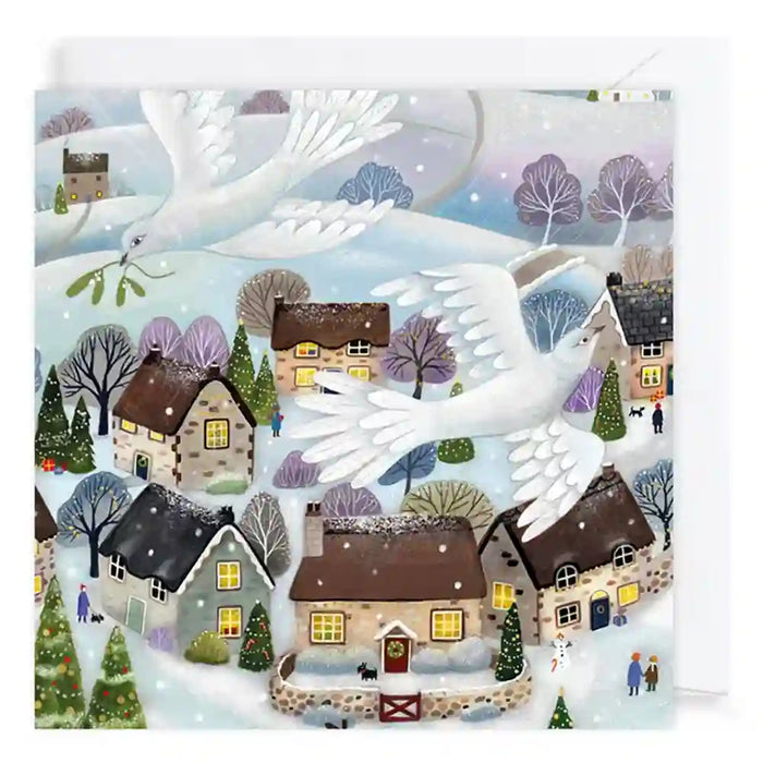 A square illustrated winter village scene with snow-covered rooftops, small houses with glowing windows, evergreen trees, and two large white birds flying across the composition. The artwork appears to be the product itself rather than a photo of a physical object in a room, so this fits Scenery.