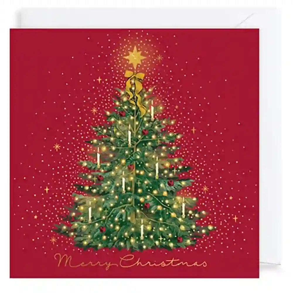 A square Christmas greeting card with a red background, featuring an illustrated green Christmas tree with gold lights, ornaments, a gold star topper, and the words 'Merry Christmas' at the bottom. A white envelope is partially visible behind the card.