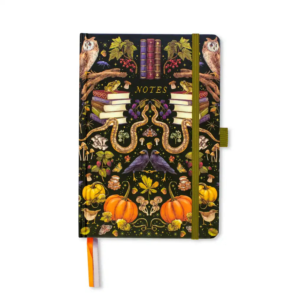 Notebook with Halloween-themed cover featuring pumpkins, owls, and books on a dark background.