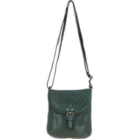 Green leather crossbody bag with a strap on a white background
