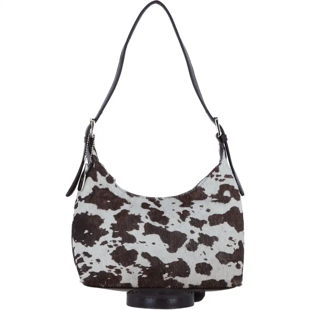 Hobo bag with brown and white cow print pattern on a white background