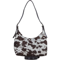 Hobo bag with brown and white cow print pattern on a white background