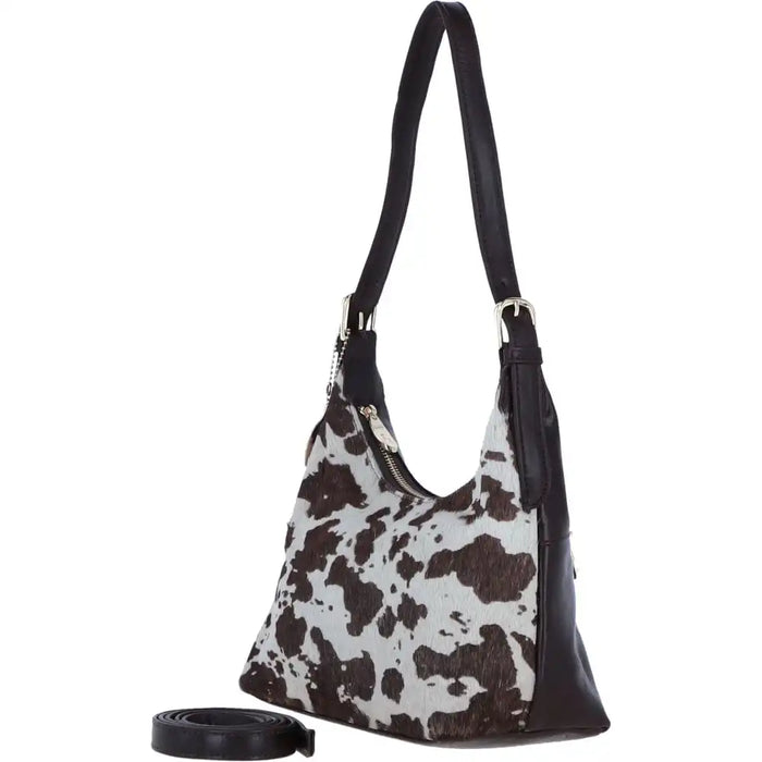Hobo bag with cow print pattern on a white background