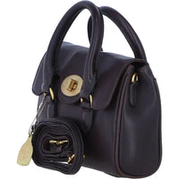 A dark navy blue leather handbag with gold-tone hardware, featuring dual top handles, a front flap with a turn-lock closure, and a matching rolled black pouch with a gold tag hanging from the side.