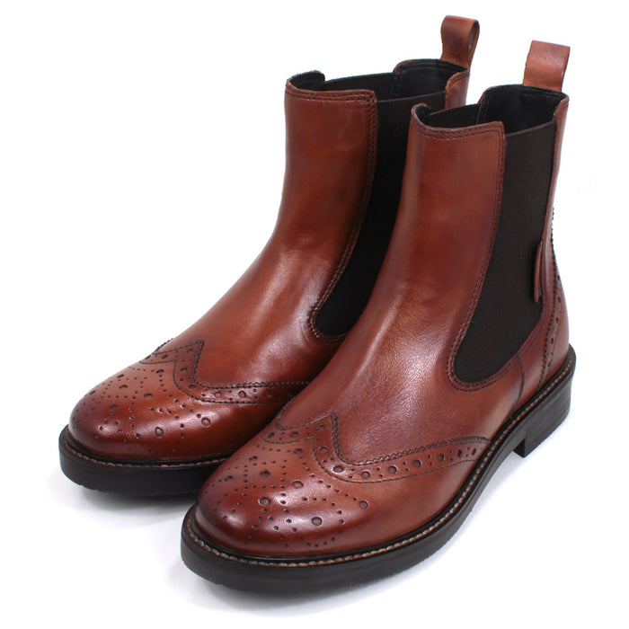 Bagatt Chelsea boots in cognac coloured leather. Brogue style punch pattern detail over the toes. Elastic panels on both sides in complementary brown. Low heels. Angled view.