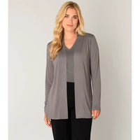 Woman wearing a gray cardigan over a black top on a plain background