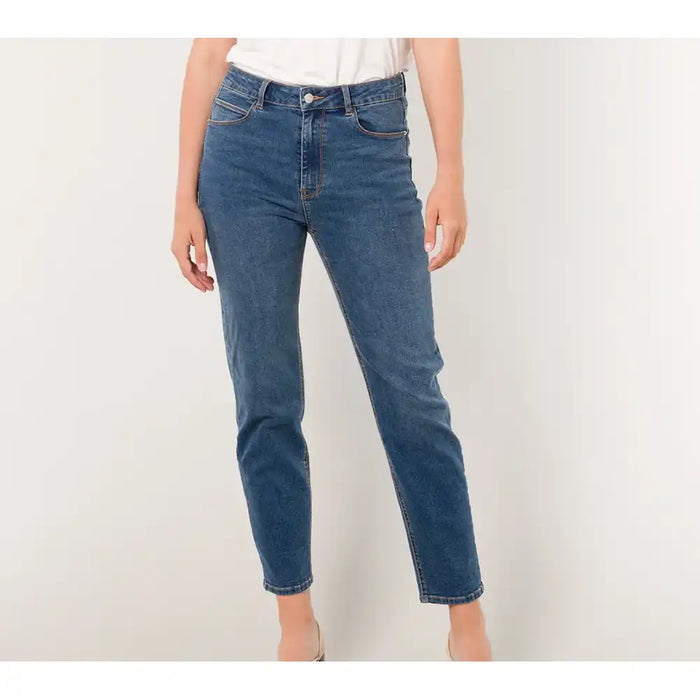 Blue jeans worn by a person on a white background