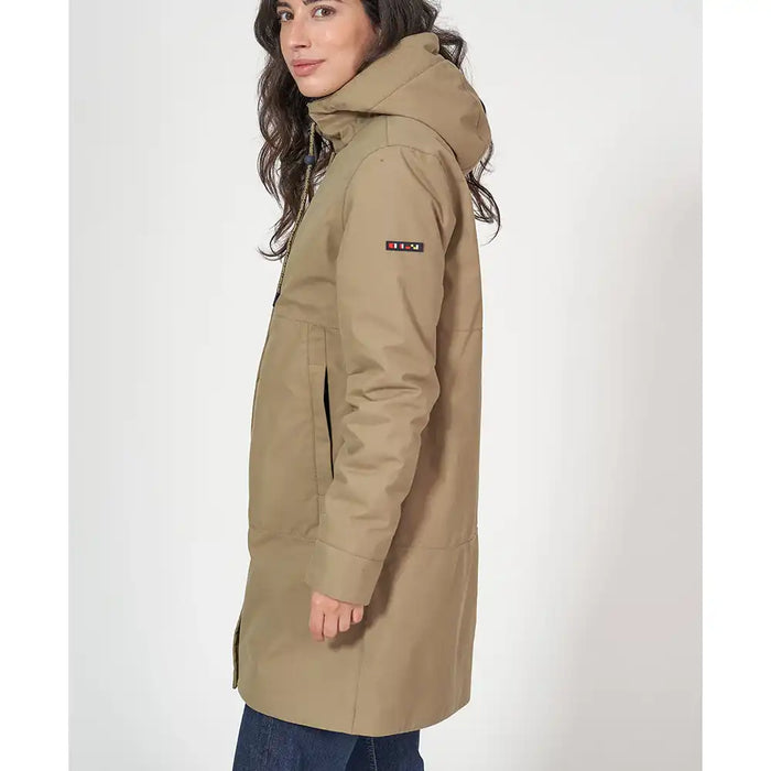 Woman wearing a beige parka with a visible brand logo on a white background