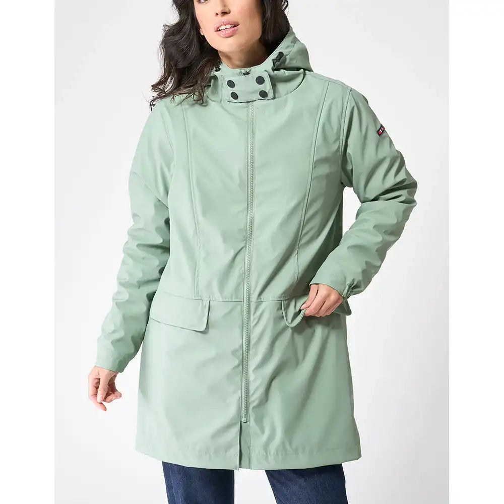 Person wearing a light green coat on a white background