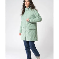 Woman wearing a light green coat on a white background