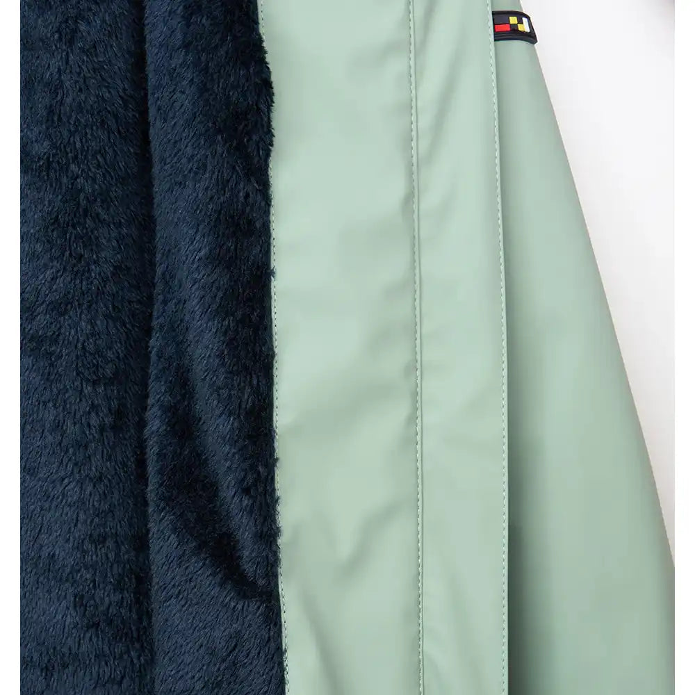 Close-up of a jacket with fur lining and a brand logo on a white background