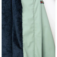 Close-up of a jacket with fur lining and a brand logo on a white background