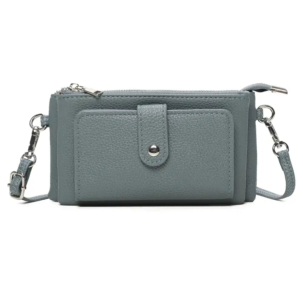 A slate blue pebbled faux leather crossbody wallet with a front pocket, silver snap button, and silver-tone hardware, shown on a white background.