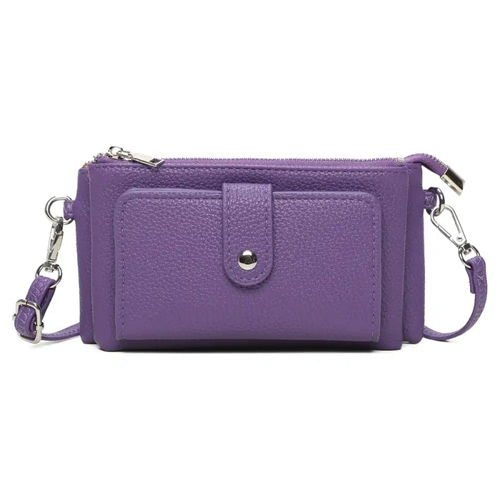 A purple textured faux-leather crossbody wallet with a front pocket, silver-tone snap button, and matching purple strap with silver hardware, shown on a plain white background.