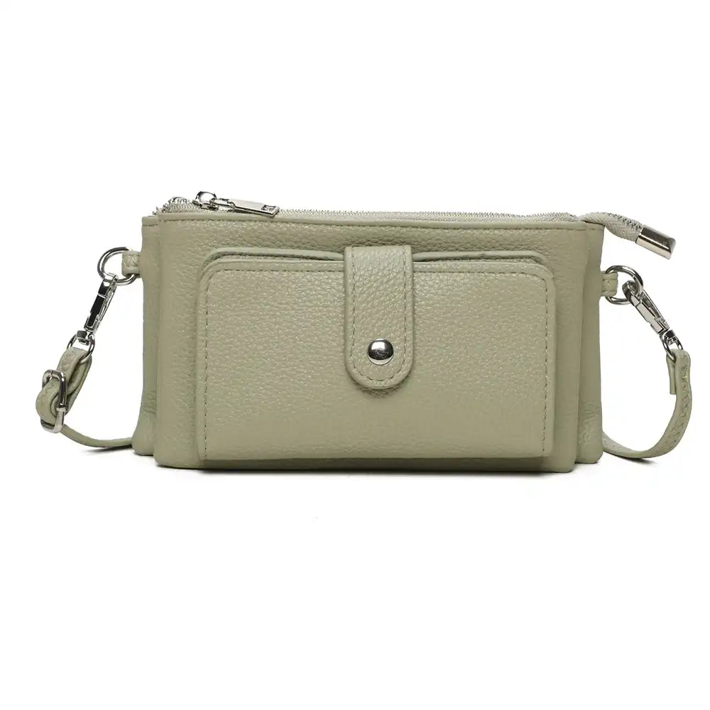 A light sage green pebbled leather crossbody wallet with a front pocket, silver snap closure, and a detachable shoulder strap, shown against a plain white background.
