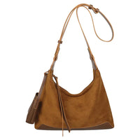 A brown suede hobo shoulder bag with a matching adjustable shoulder strap and a small side pouch, shown against a plain white background.