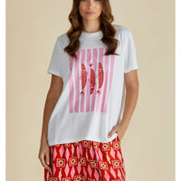 White tee with vertical pink lines in the middle with three red sardines in the middle. Round neckline and short sleeves. 