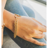 tight chained bracelet in gold with a T-bar and hoop fastening.