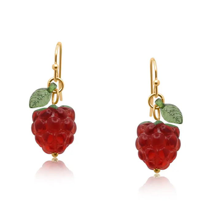 Raspberries with green leaves attached to a golden hook.