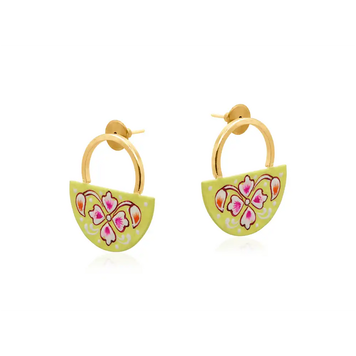 Golden semi circle earring with a half circle yellow plaque which has a floral design on it. 