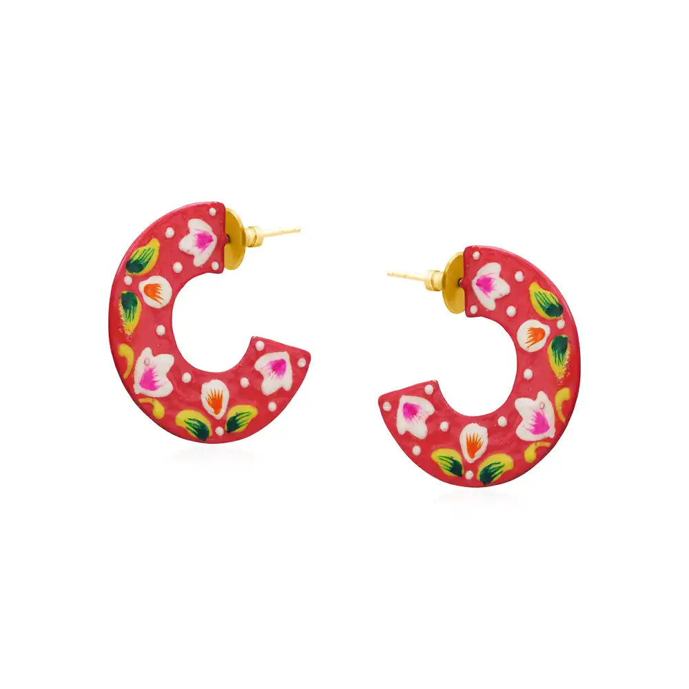 Red semi circle earrings with a floral motif