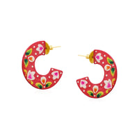 Red semi circle earrings with a floral motif