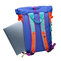 Billy Belts bright multi coloured roll top back pack. View of straps and pocket which is against the body when wearing the bag.