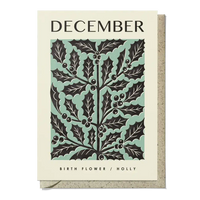 Card with holly leaf design and 'December' text on a beige background