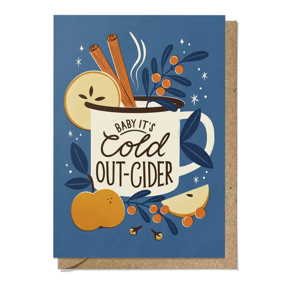 Greeting card with a mug of cider, apples, cinnamon sticks, and berries on a blue background.