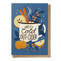 Greeting card with a mug of cider, apples, cinnamon sticks, and berries on a blue background.