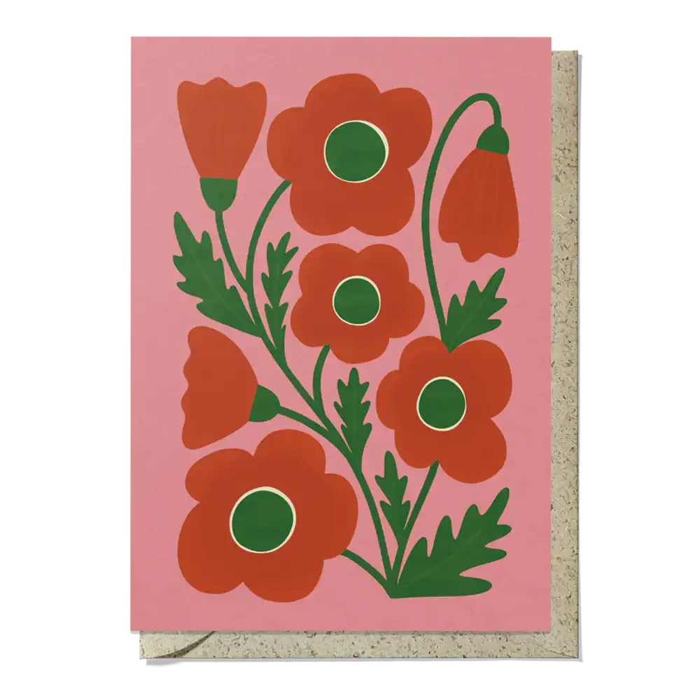 Card with red floral design on a pink background