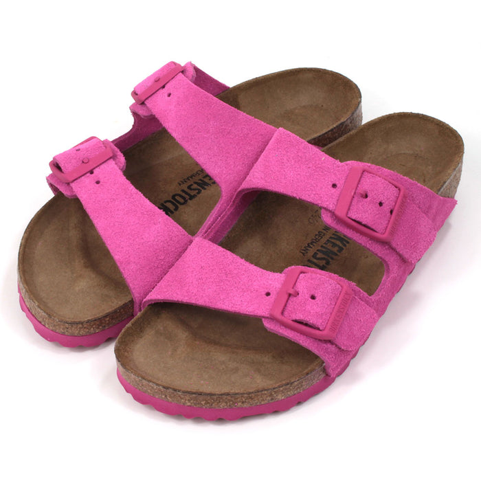 Birkenstock Arizona sandals in fuchsia tulip colour. Double straps with matching buckles and soles. Cork insoles. Angled view.