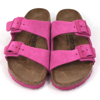 Birkenstock Arizona sandals in fuchsia tulip colour. Double straps with matching buckles and soles. Cork insoles. Front view.