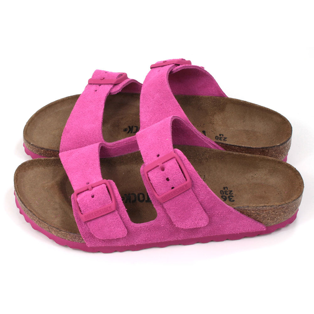 Birkenstock Arizona sandals in fuchsia tulip colour. Double straps with matching buckles and soles. Cork insoles. Side view.