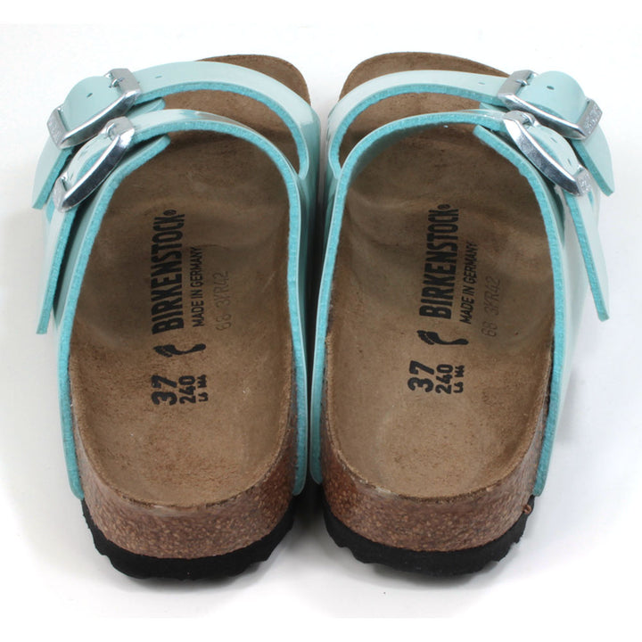 Birkenstock cork and rubber soled, two strap sandals. Two silver buckles on two patent surf green wide straps. Backless design with sculpted insole. Back view.